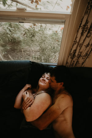 couples cozy morning in home session with dogs